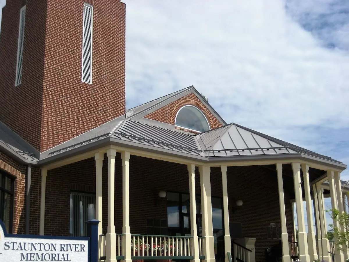 Skilled roofing craftsmen working on a residential roof in Welch